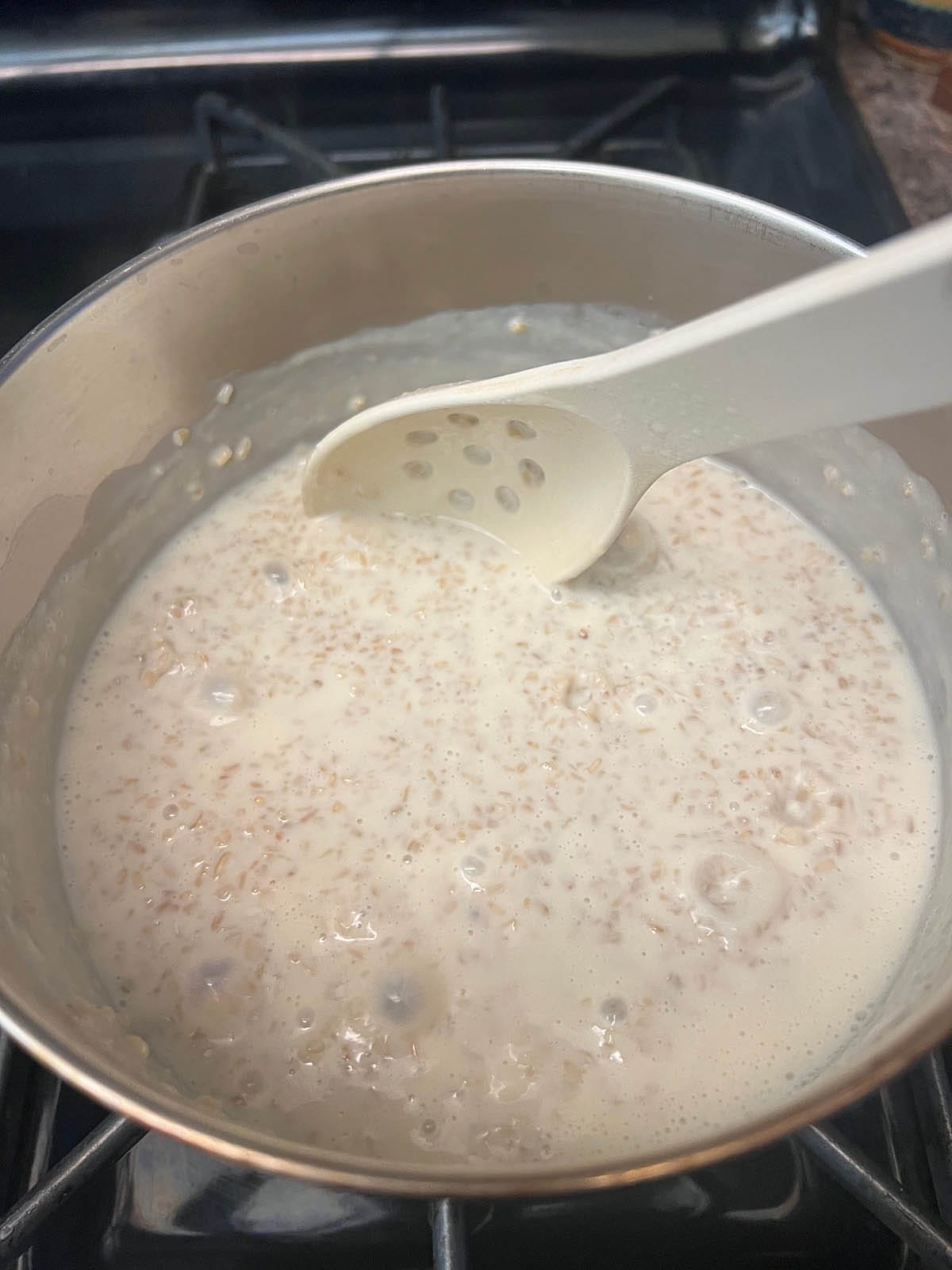 Steel cut oats and almond milk in a saucepan.