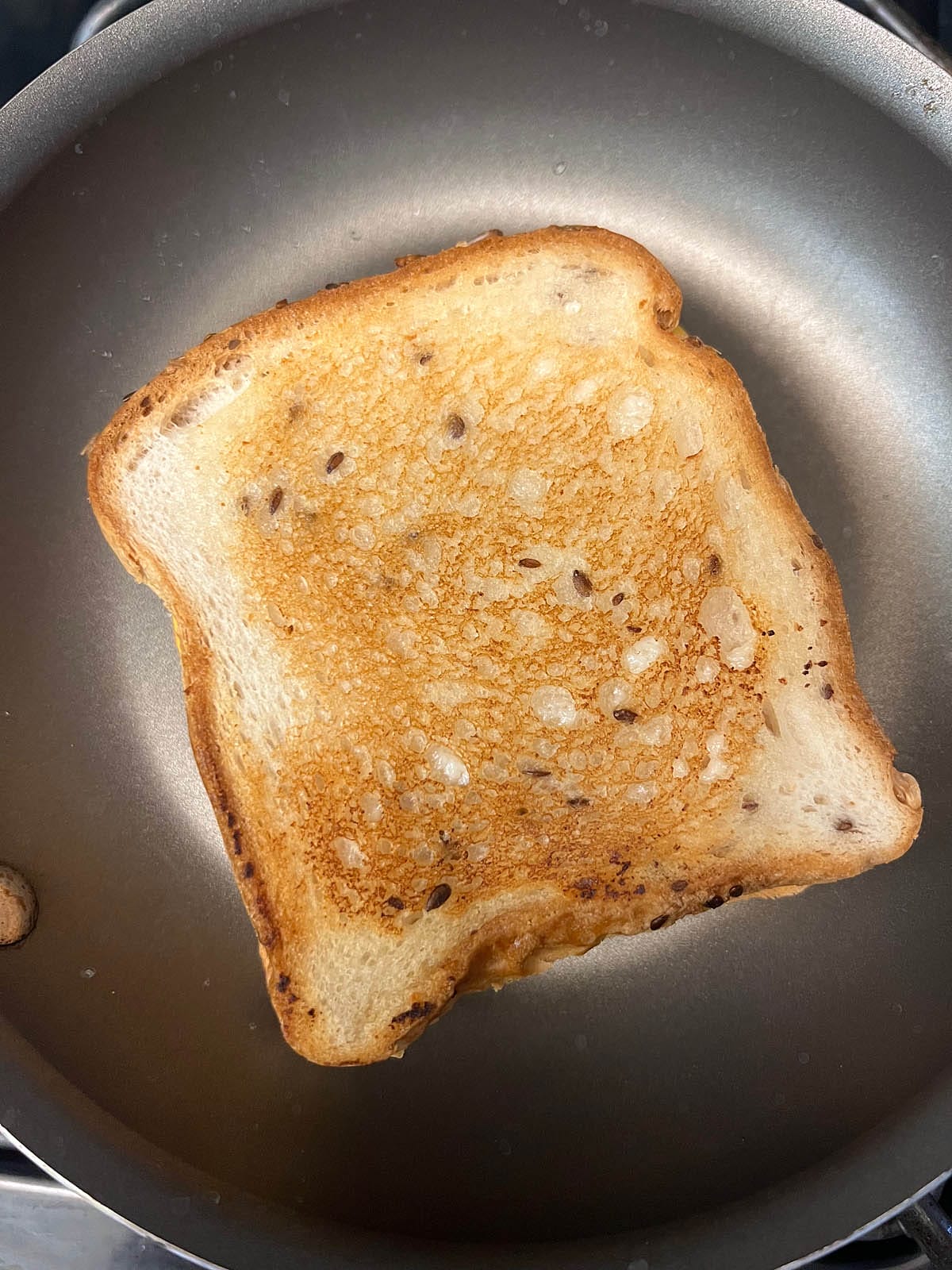 Refried bean grilled cheese in a skillet.