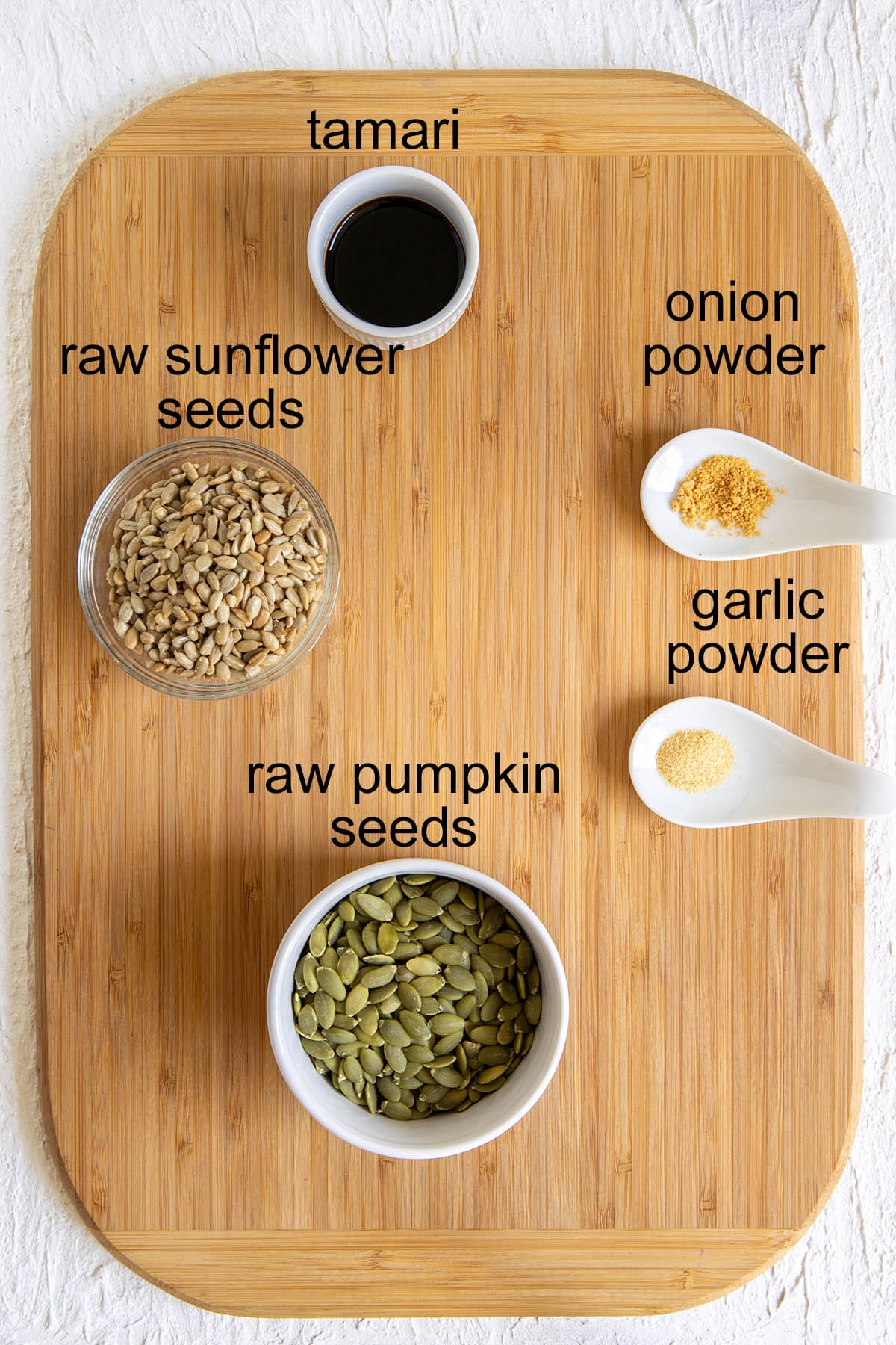 Tamari pumpkin and sunflower seed ingredients on a cutting board with labels.