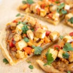 Thai Pizza on a cutting board.