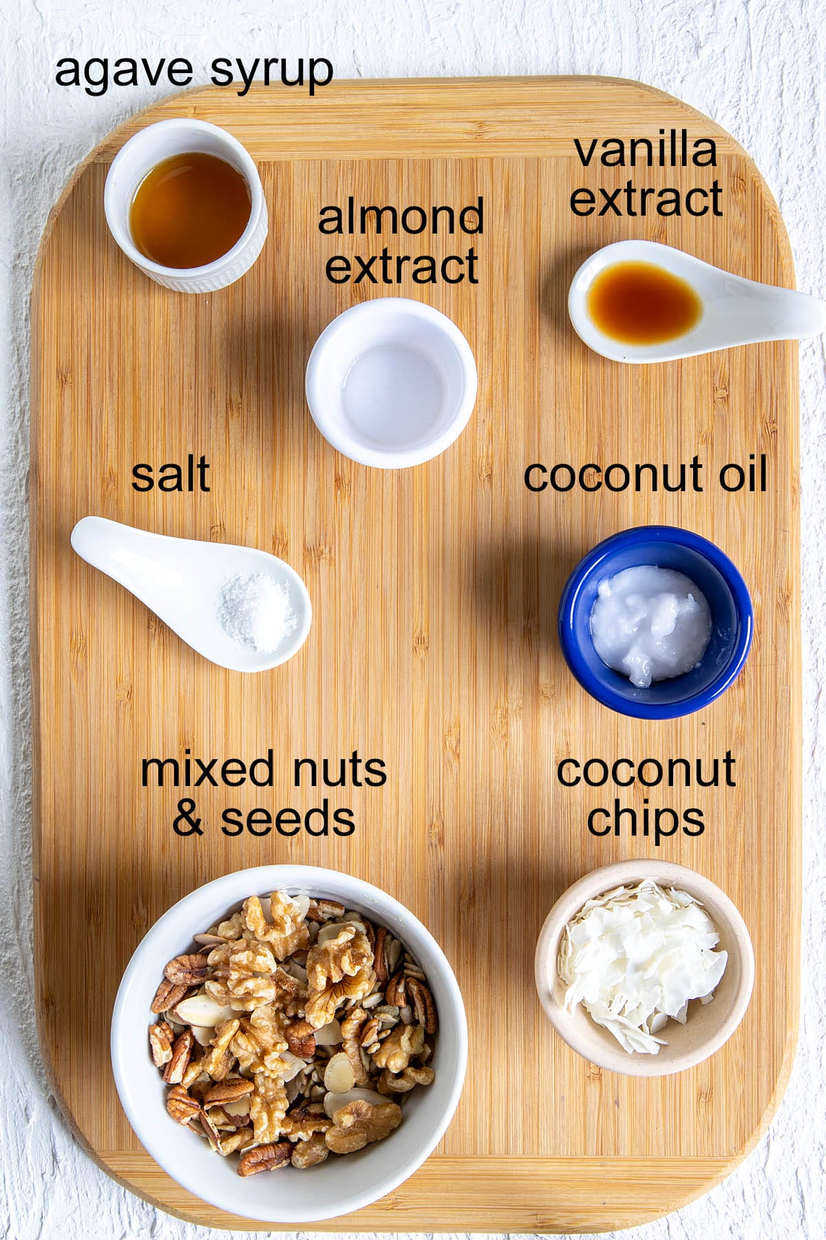 Grain free granola ingredients on a cutting board with labels.