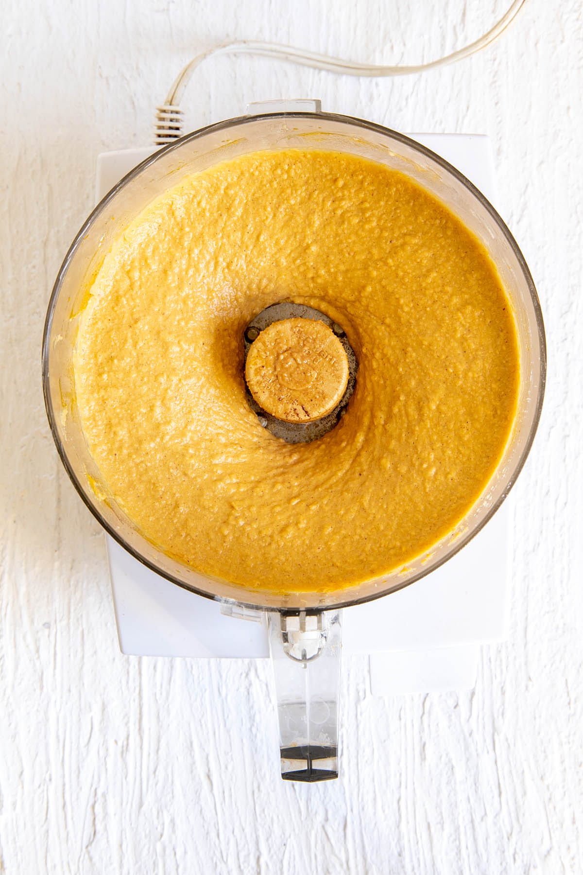 Pumpkin chickpea blondie mixture in a food processor.