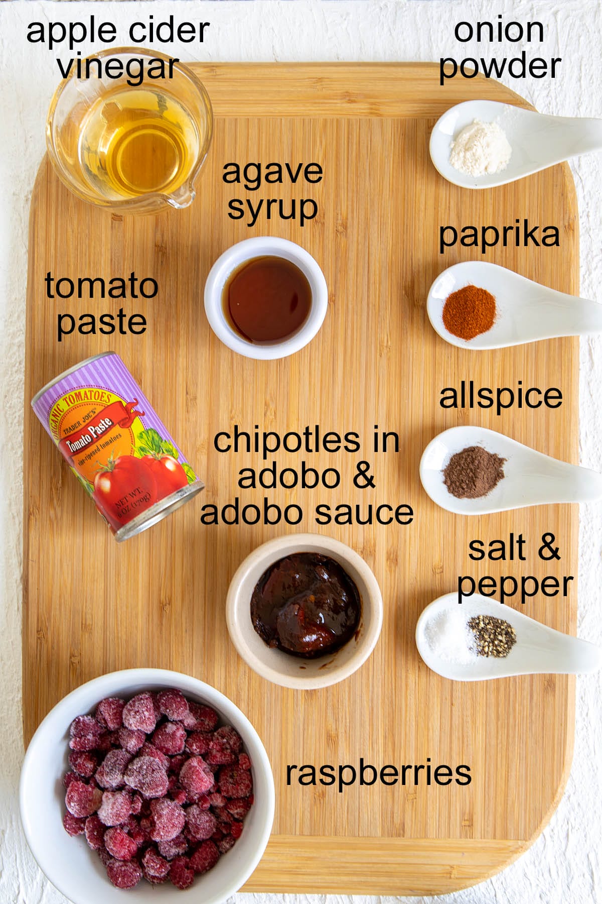Raspberry Chipotle Ketchup ingredients on a cutting board with labels.