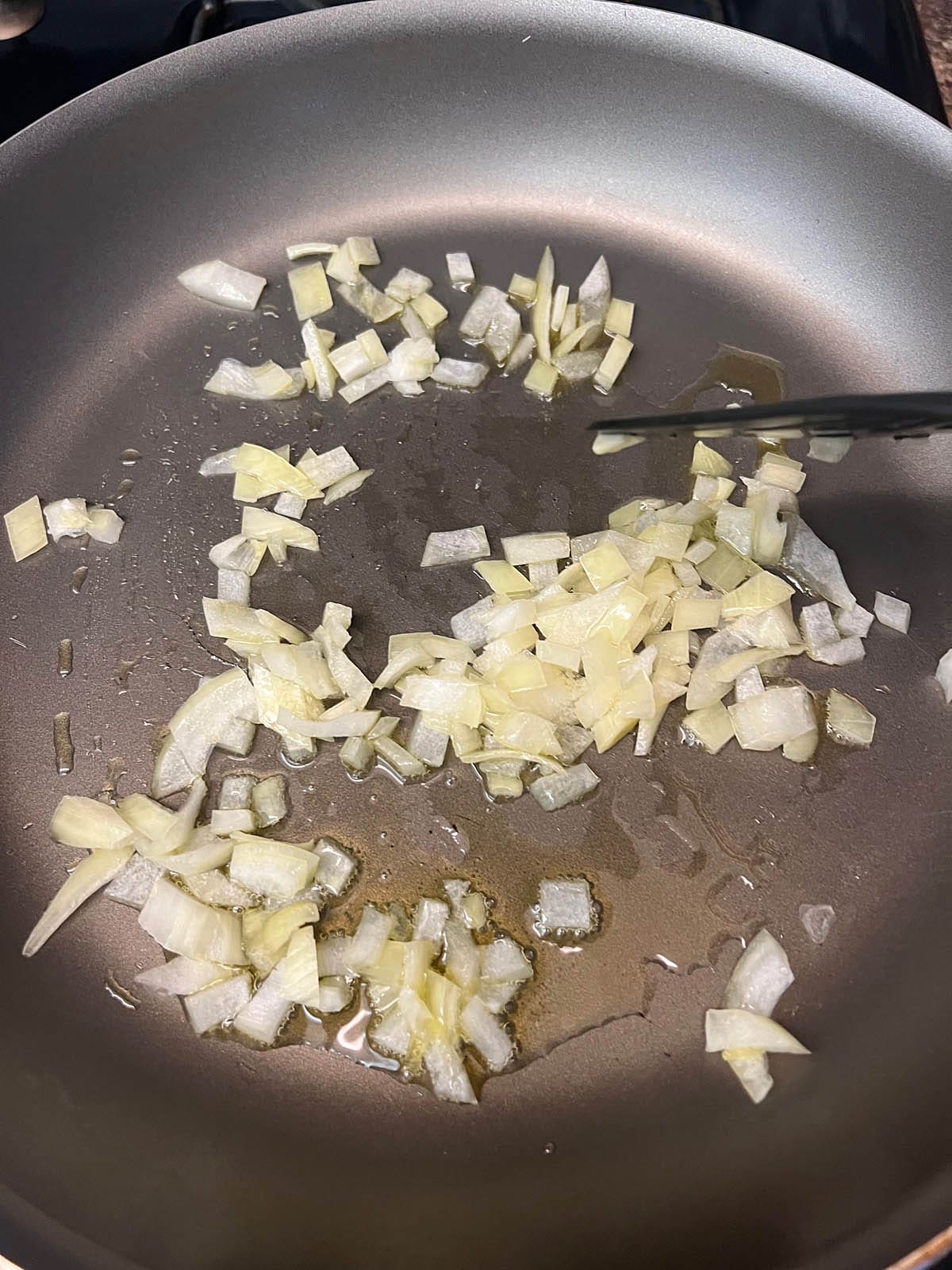 Chopped onions in a skillet.