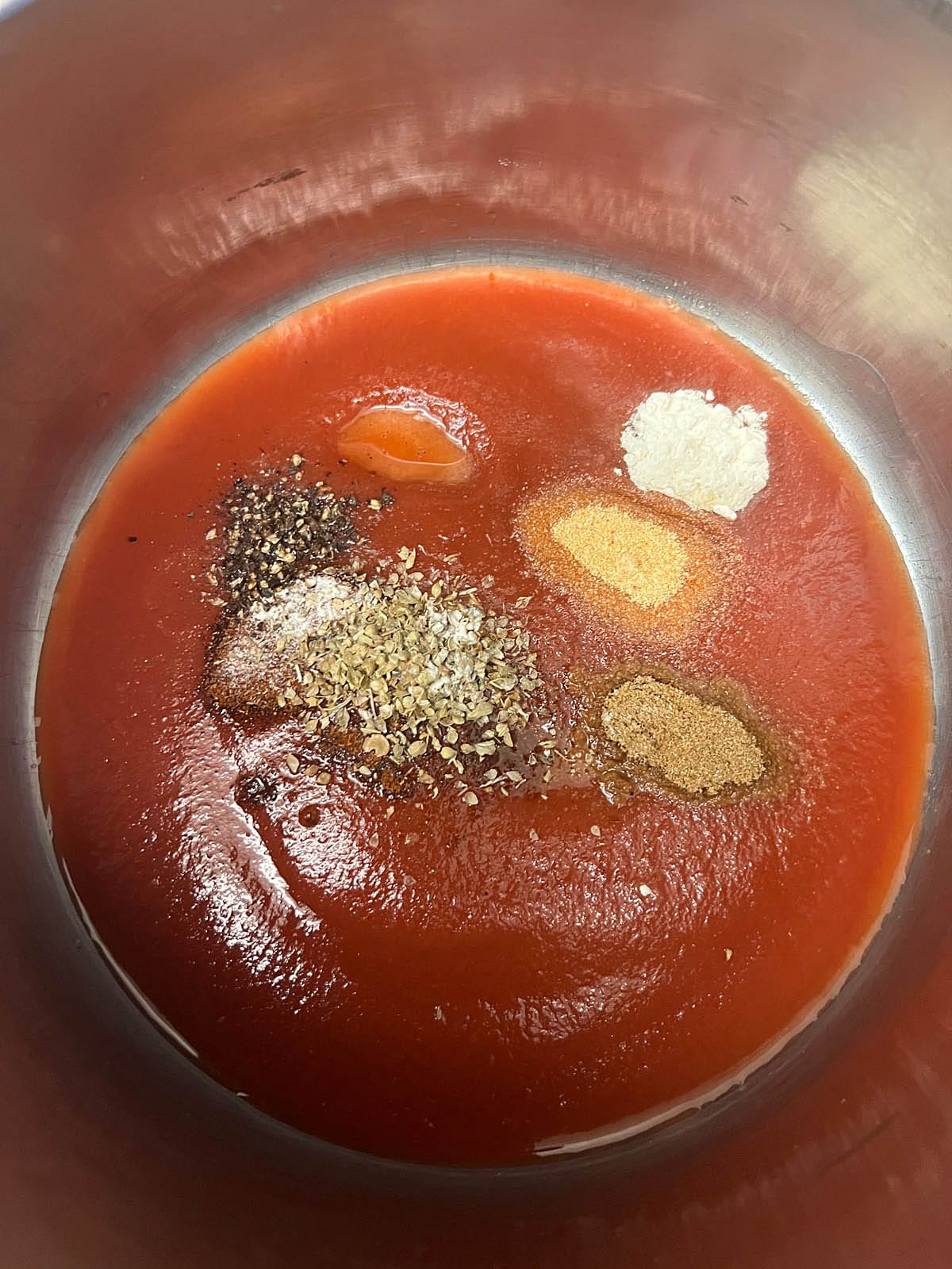 Enchilada sauce ingredients in a saucepan.