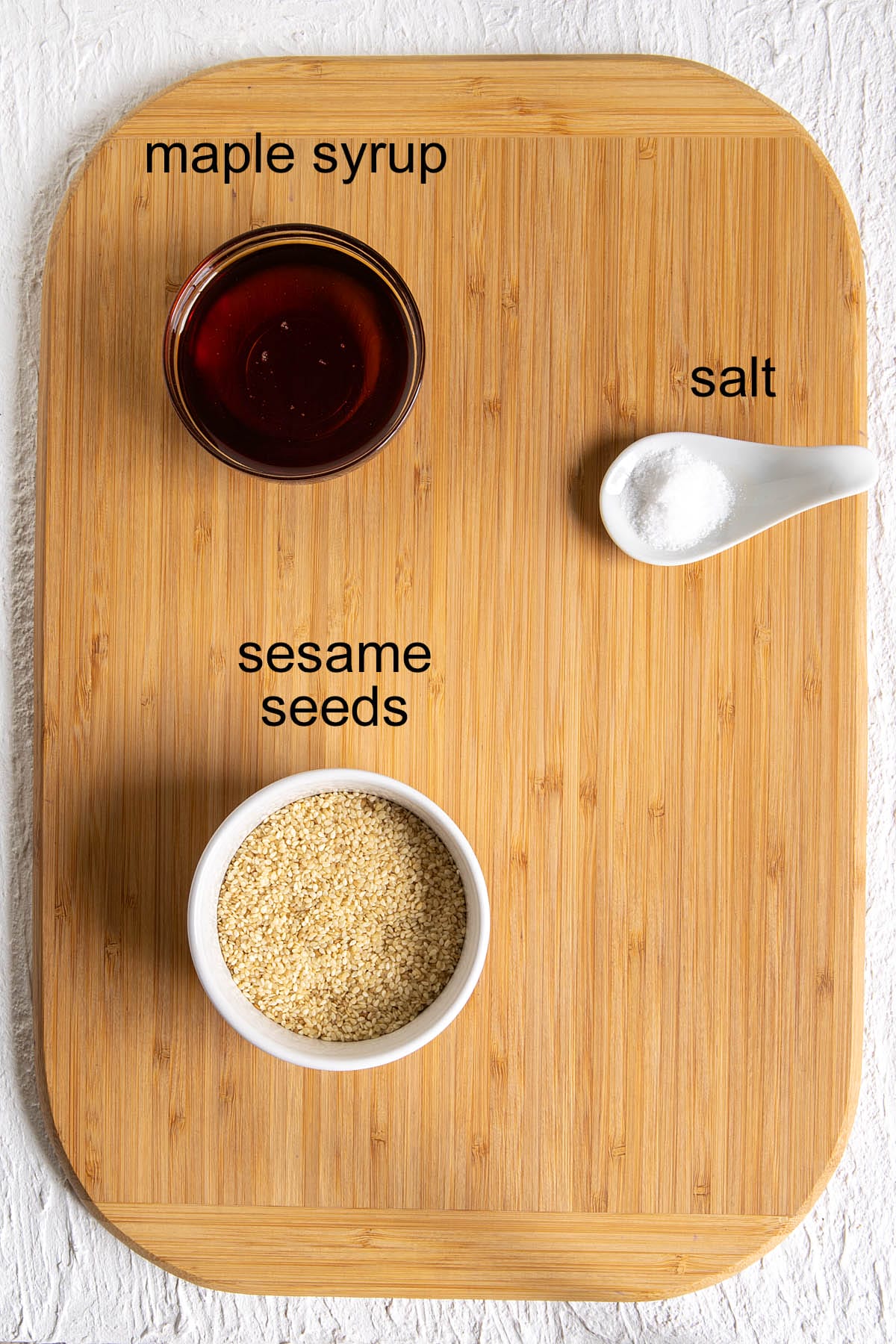 Sesame crunch bar ingredients on a cutting board with labels.