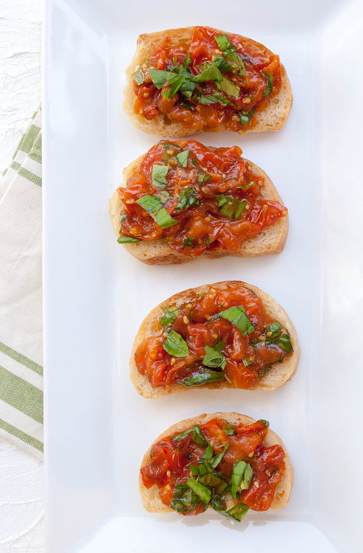 Roasted Tomato Bruschetta on a plate with napkin.