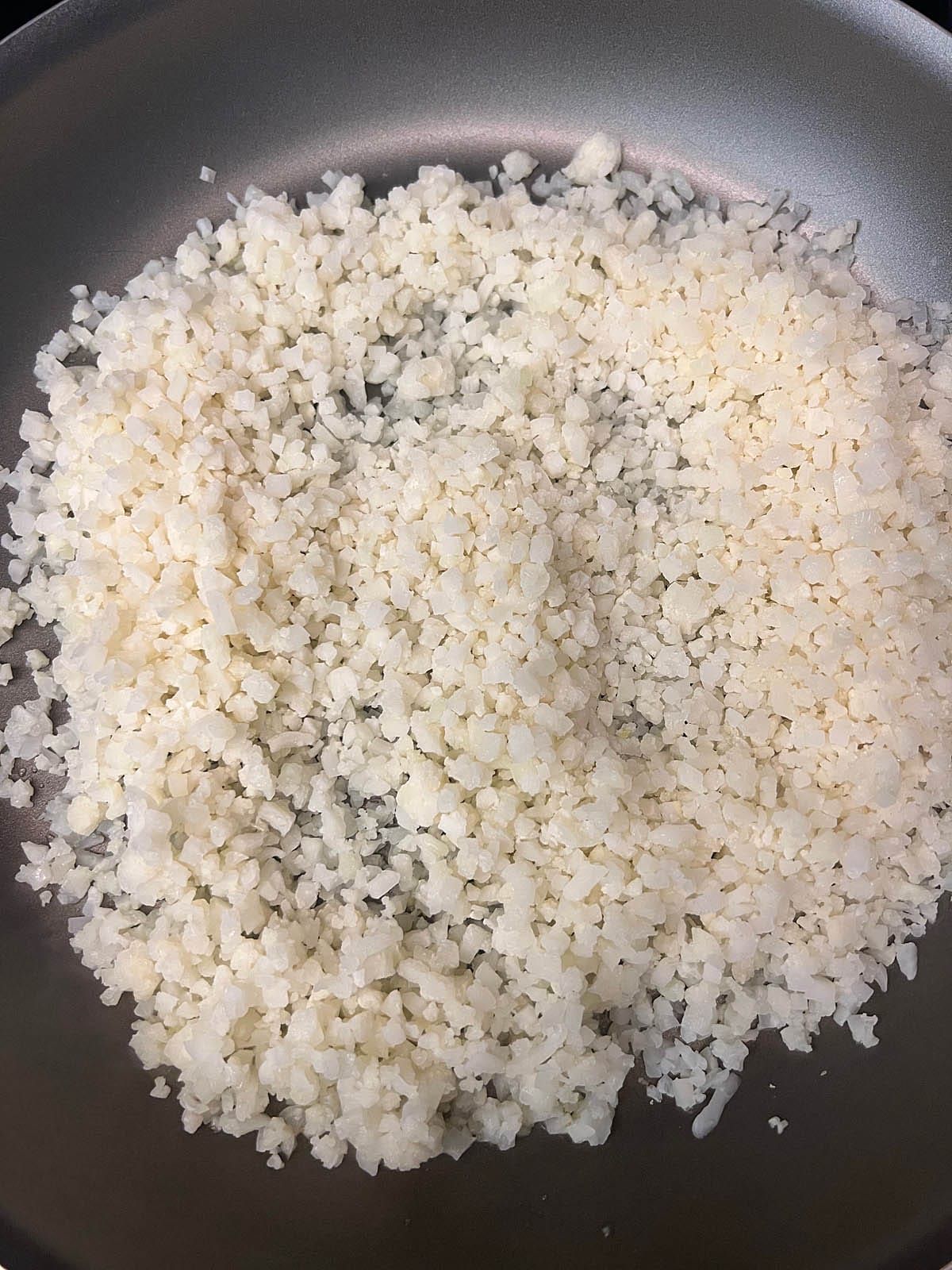 Cauliflower rice in a pan.