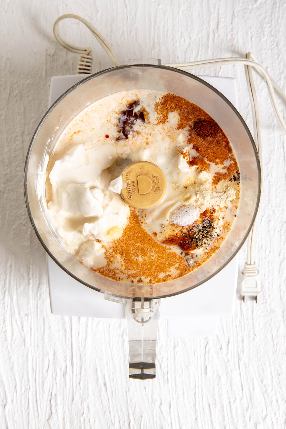 Chipotle ranch ingredients in a food processor.