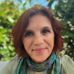 Willow Moon in front of bushes.