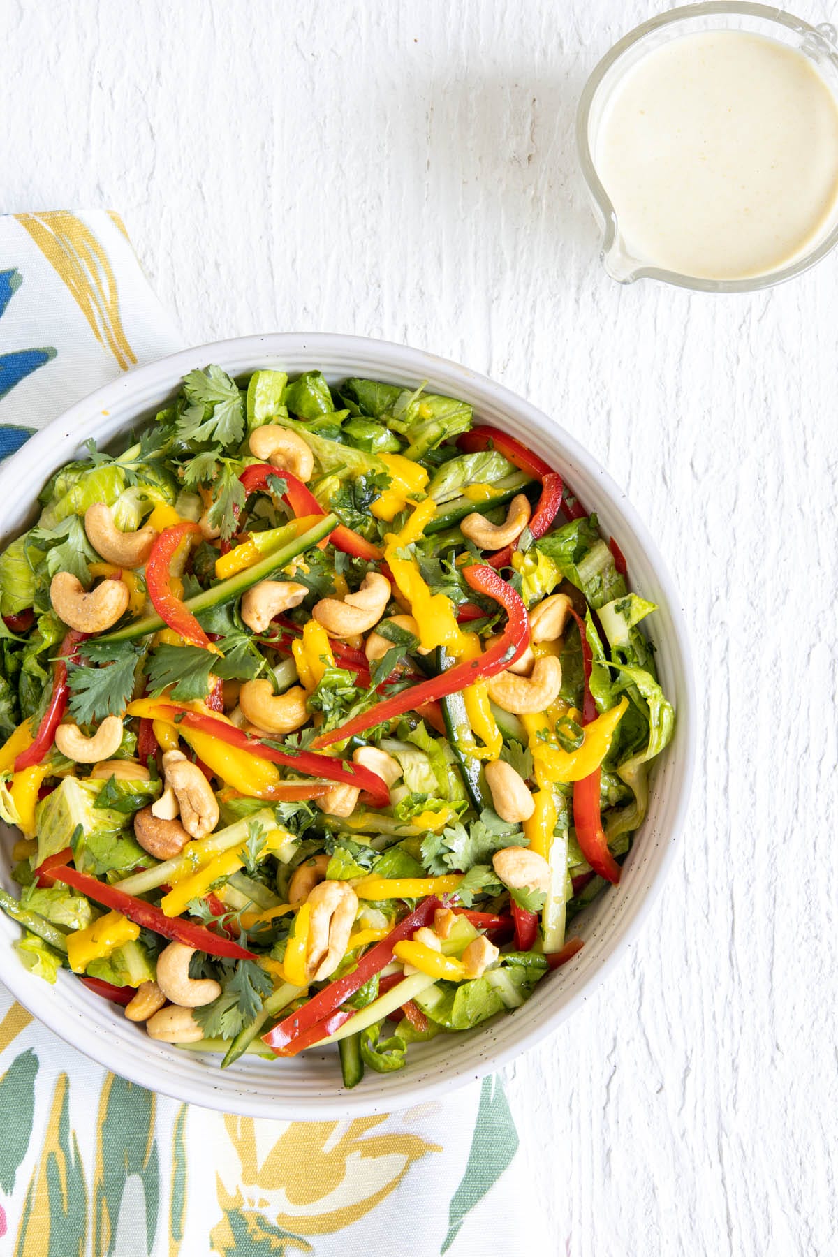 Thai Green Curry Salad with pitcher of dressing.