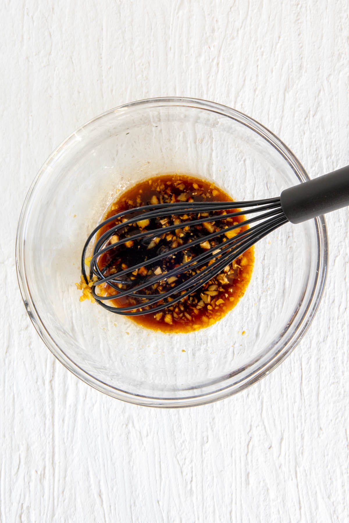 Sauce ingredients in a mixing bowl with whisk.