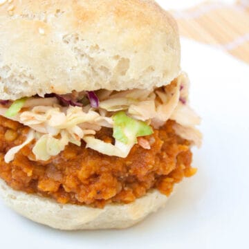 BBQ Lentil Sandwich with sriracha coleslaw on a plate.