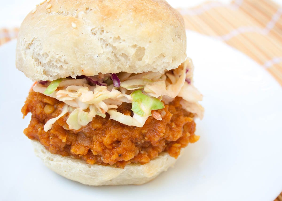 BBQ Lentil Sandwich with sriracha coleslaw on a plate.
