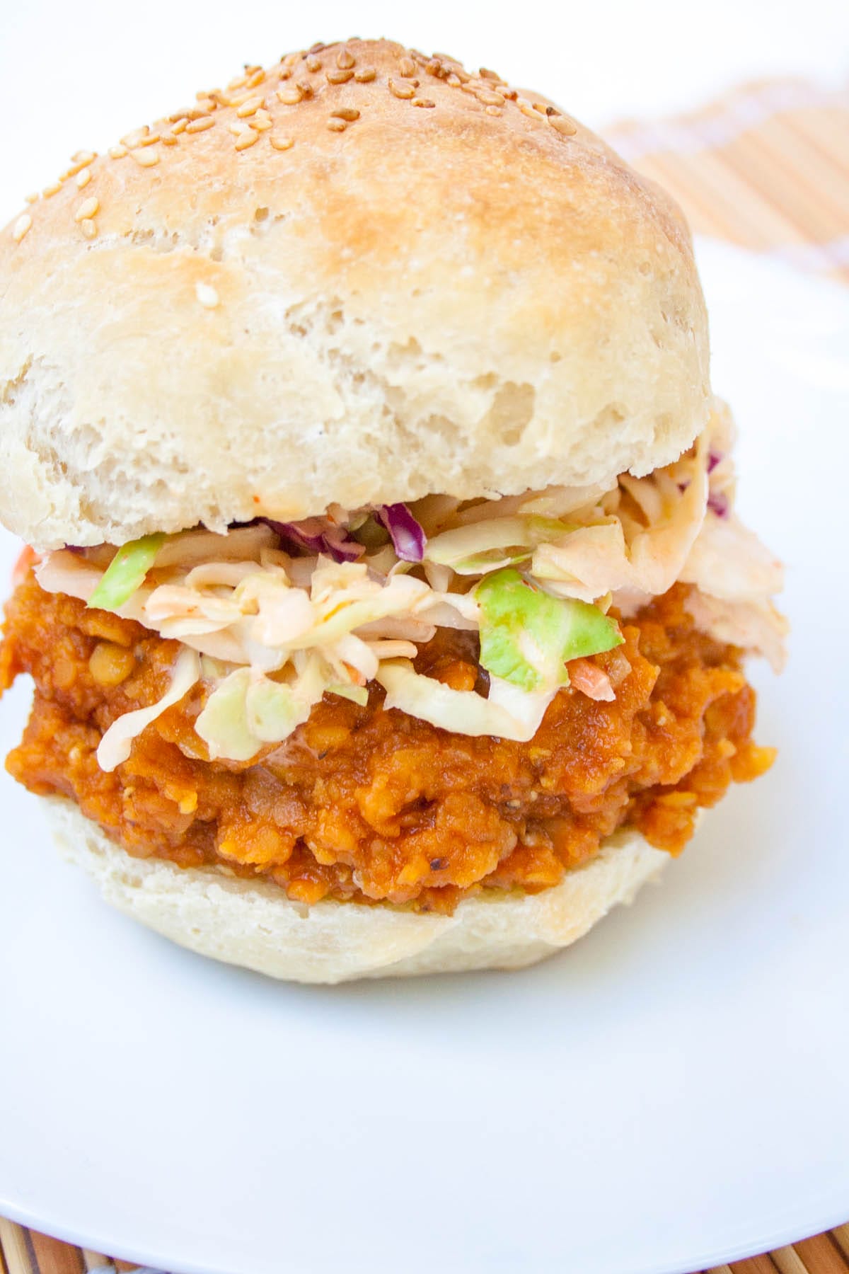 BBQ Lentil Sandwich with sriracha coleslaw on a plate.