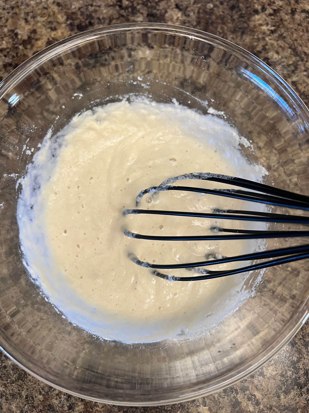 Tempura batter in a mixing bowl with whisk.