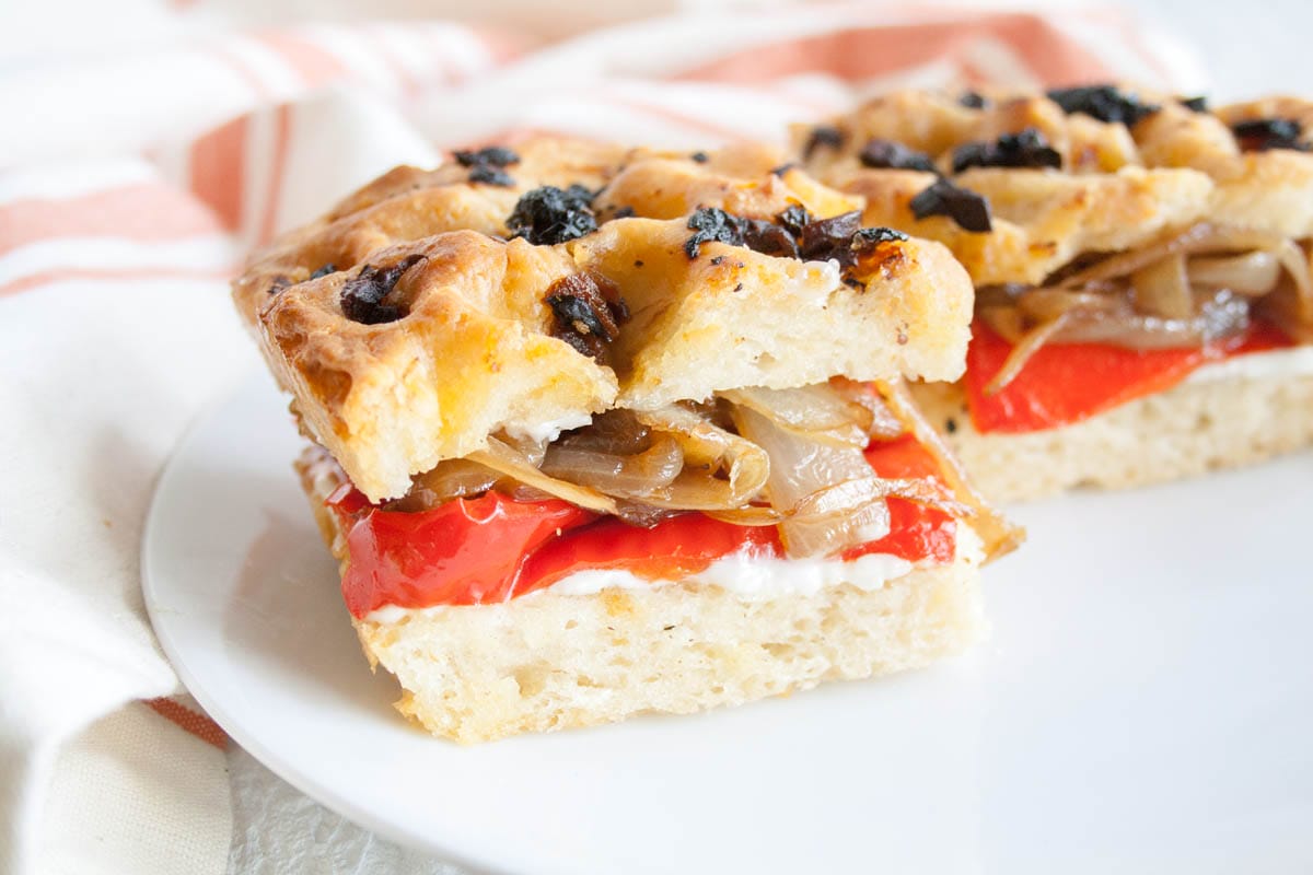 Roasted Red Pepper and Caramelized Onion Focaccia Sandwich on a plate.