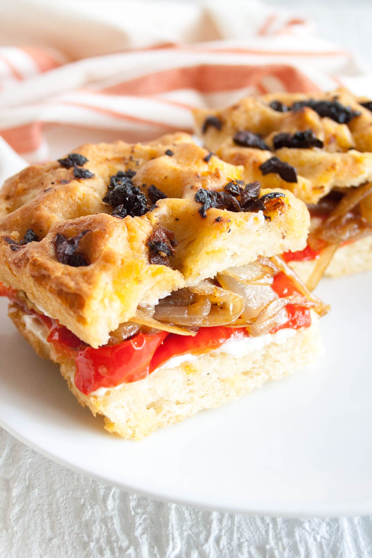Roasted Red Pepper and Caramelized Onion Focaccia Sandwich on a plate.