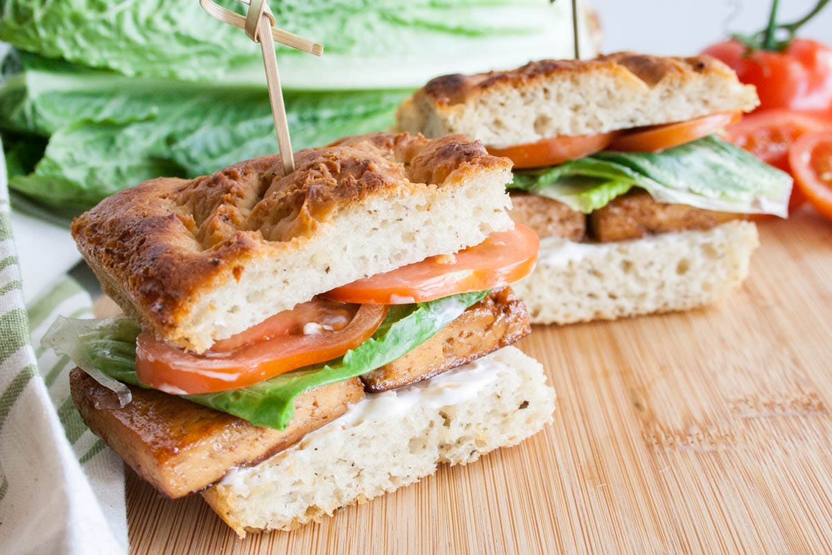 Vegan BLT Focaccia Sandwich a cutting board.