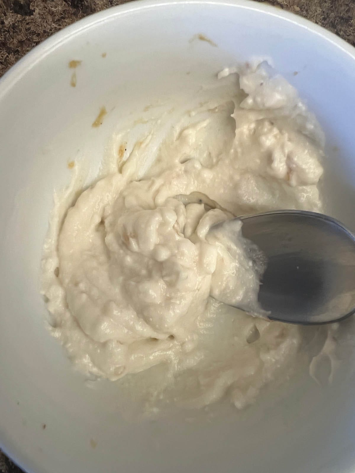 Roasted garlic mixed with vegan mayo in a small bowl.