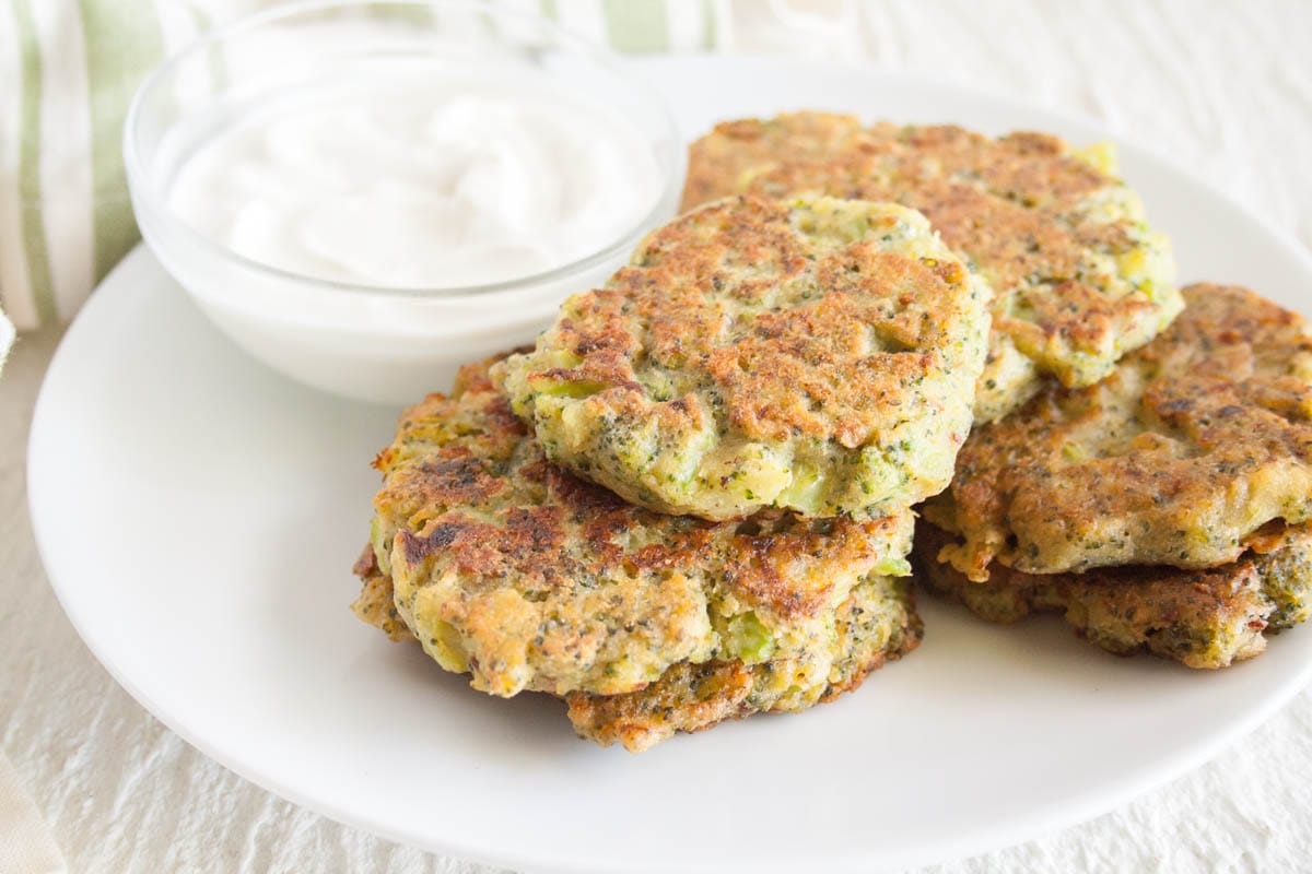 Broccoli Fritters on a plate with dipping sauce.