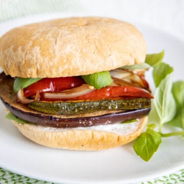 Balsamic Roasted Vegetable Sandwich on a plate with basil.