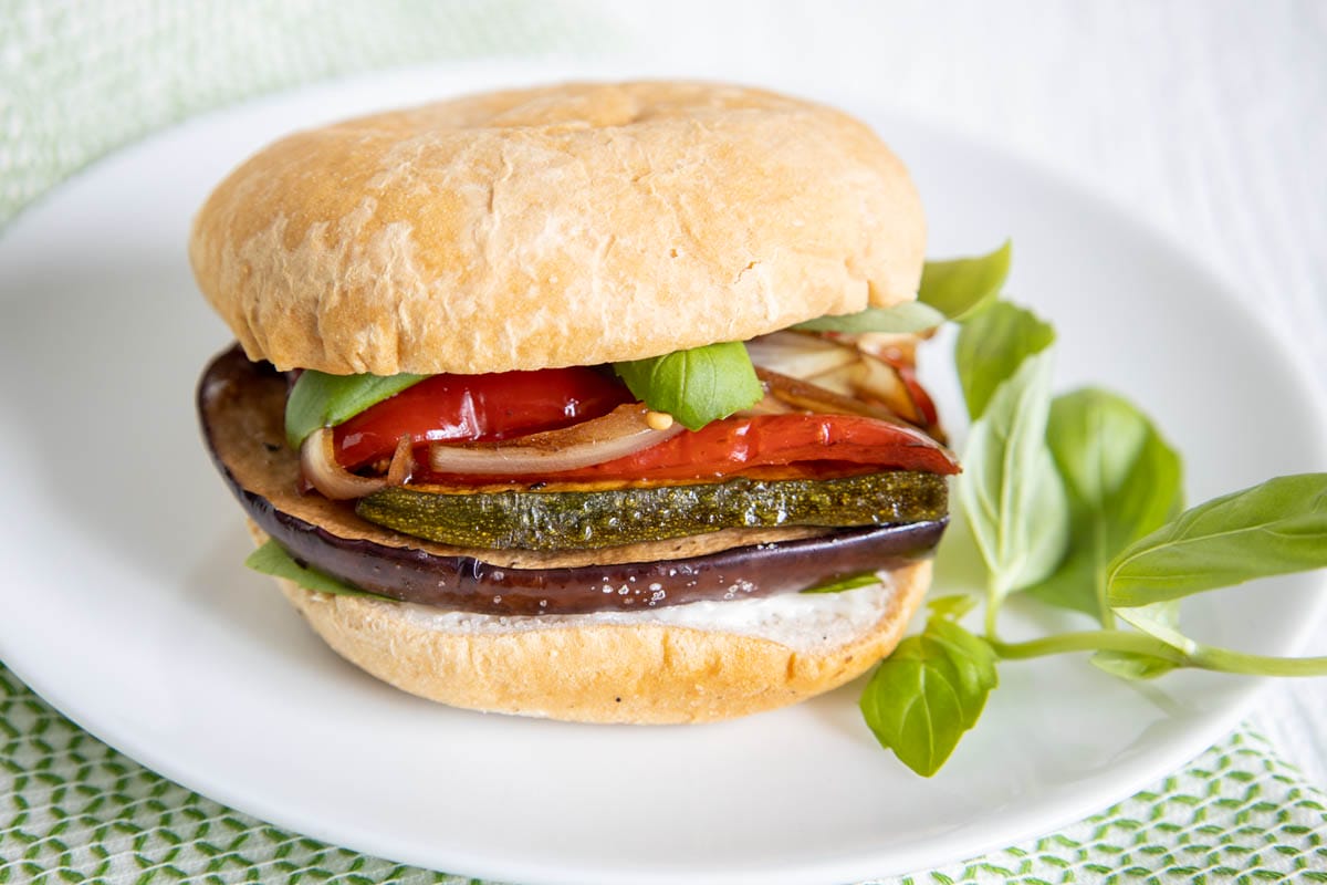 Balsamic Roasted Vegetable Sandwich on a plate with basil.