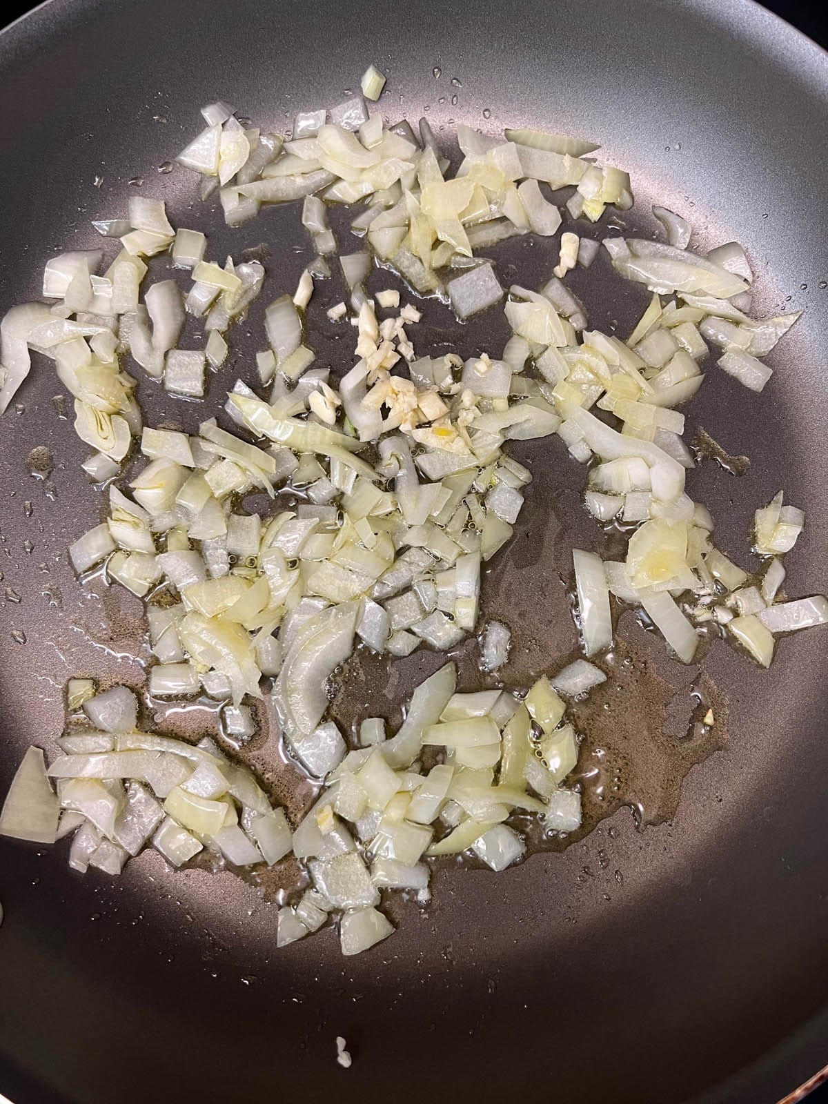 Cooked onions and garlic in a skillet.