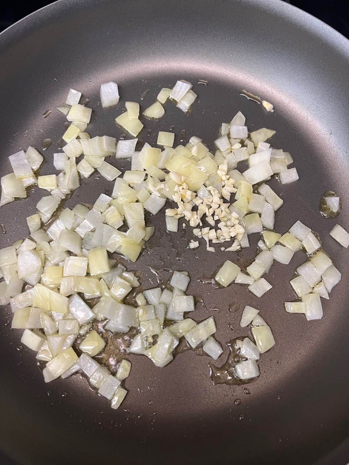 Cooked onions and garlic in a pan.