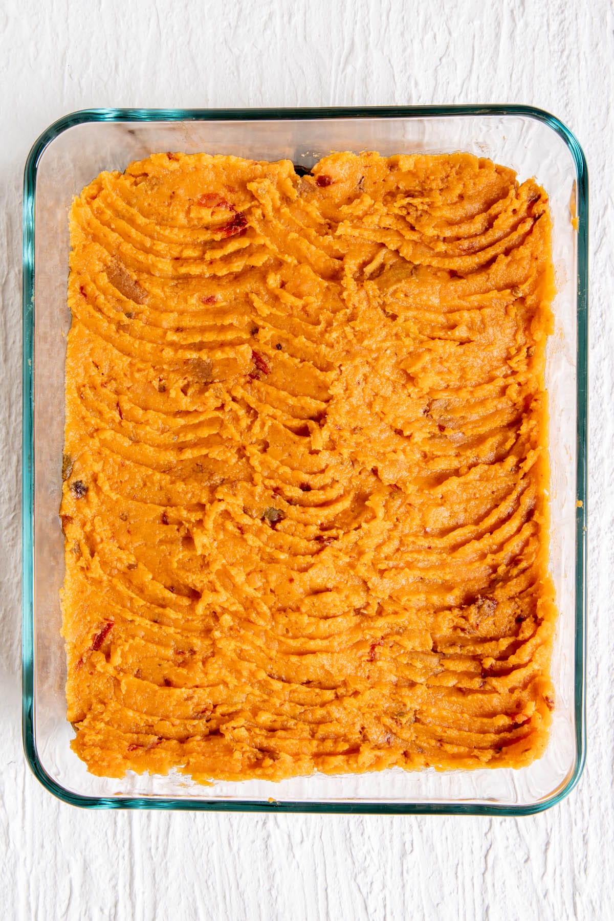 Black bean mixture with mashed chipotle sweet potatoes on top.