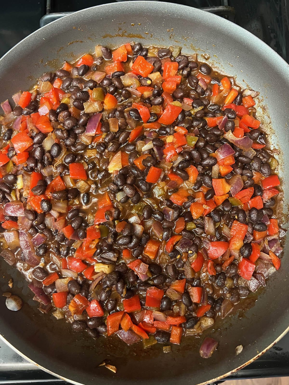 Black beans added to the pan.