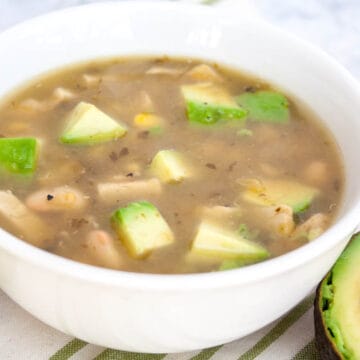 4 Ingredient Vegan Chili Verde in a bowl with avocado and lime.