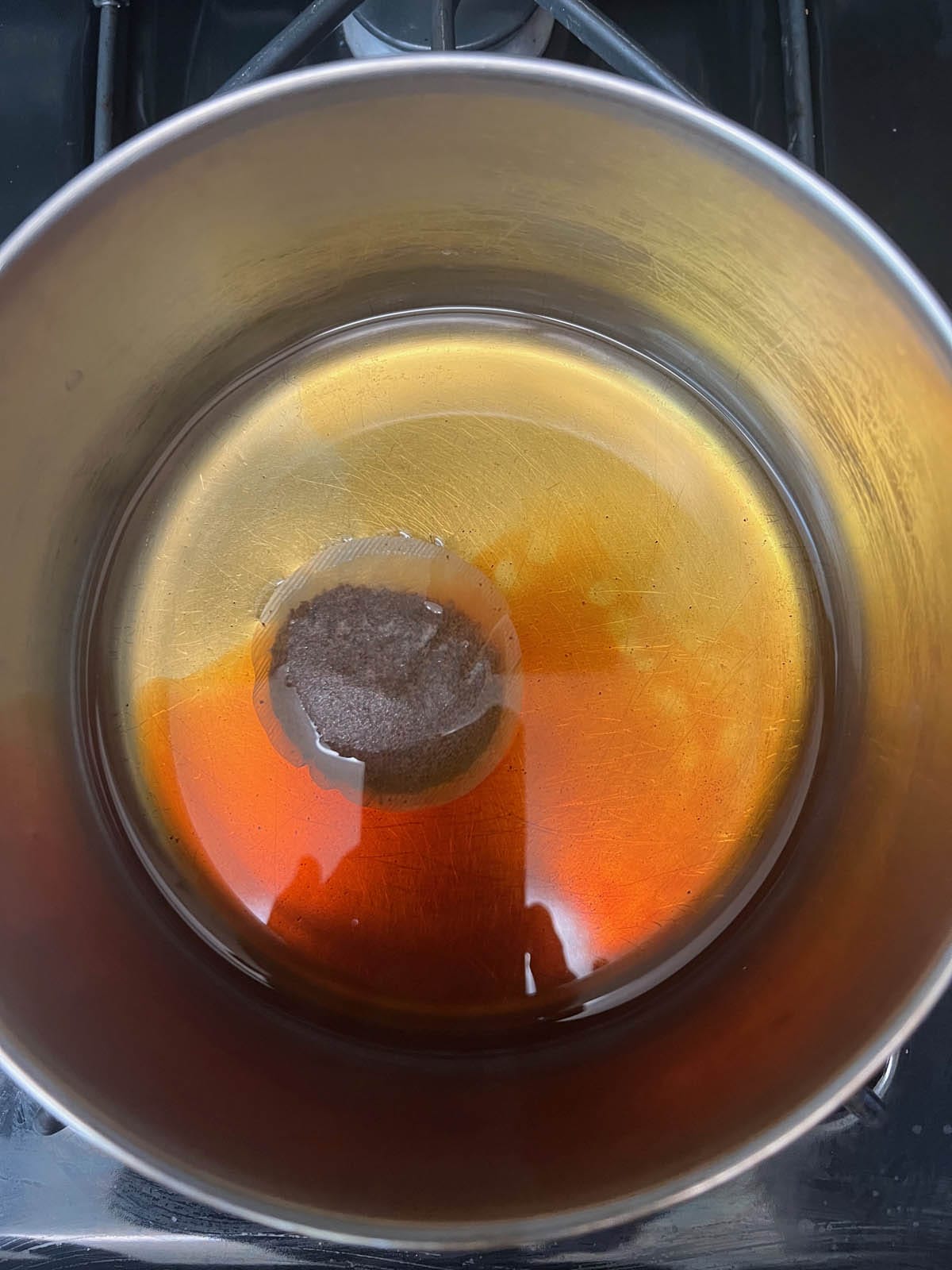 Black tea in a saucepan with water.