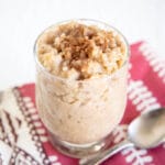Vegan Rice Pudding in a jar with spoon.