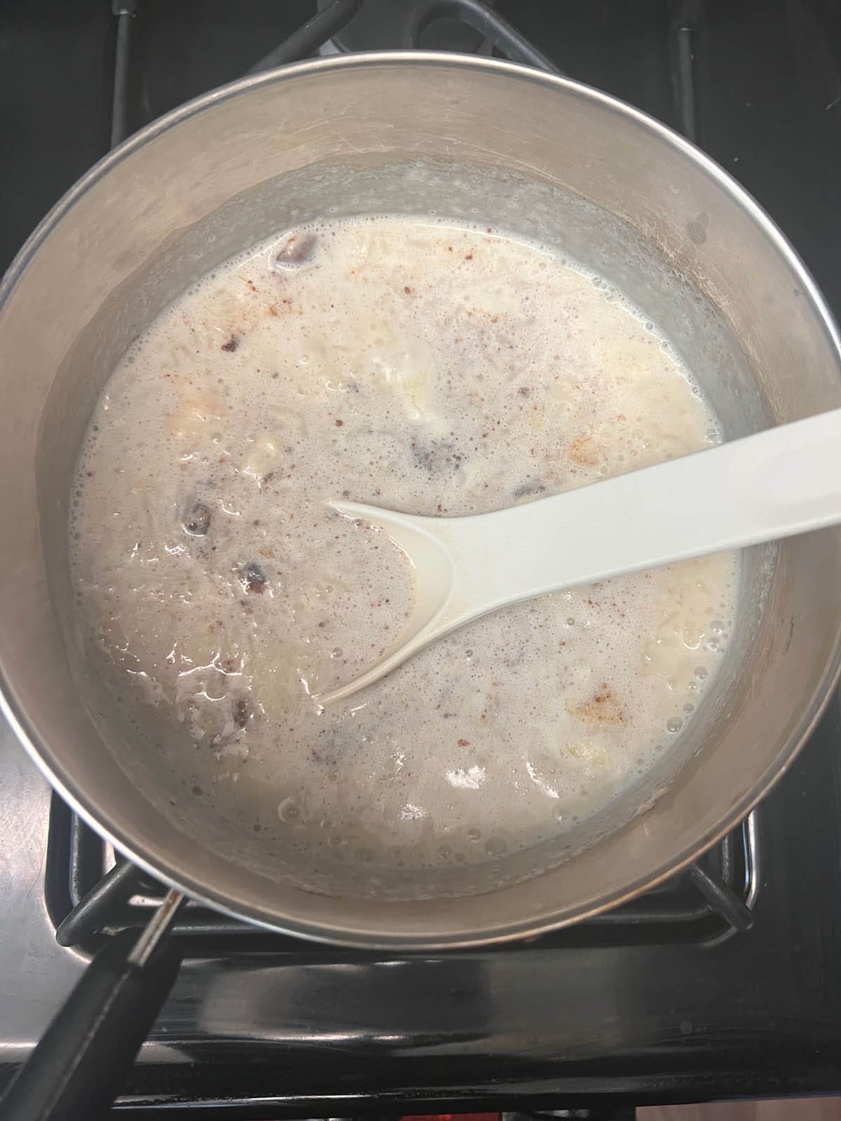 Rice pudding cooking in saucepan.