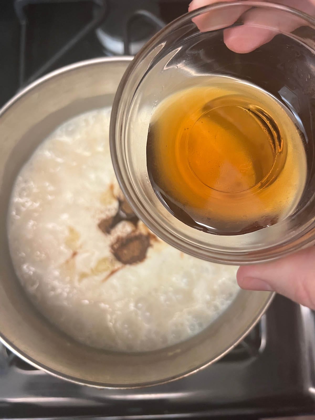 Maple syrup and spices added to the saucepan.