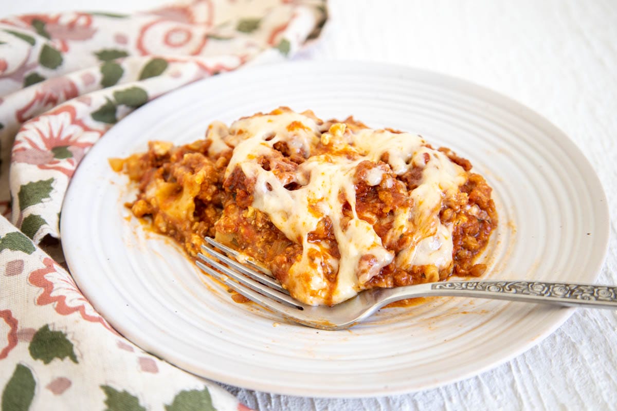 Vegan Slow Cooker Lasagna on a plate with fork.