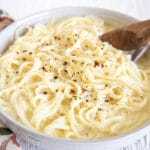 Tofu Alfredo in a bowl with spoon.