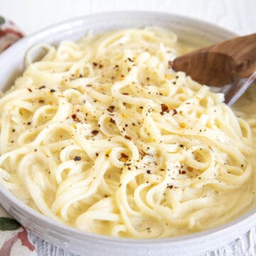 Tofu Alfredo in a bowl with spoon.