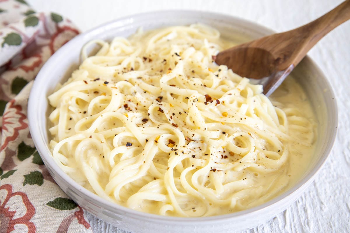 Tofu Alfredo in a bowl with spoon.