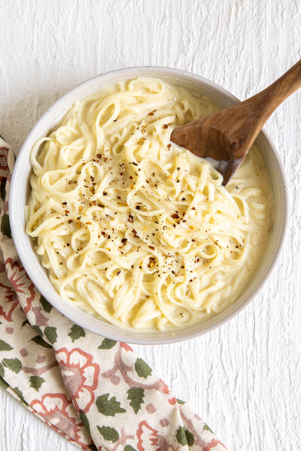 Tofu Alfredo in a bowl with spoon.