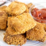 Panko Tofu on a plate with sauce.