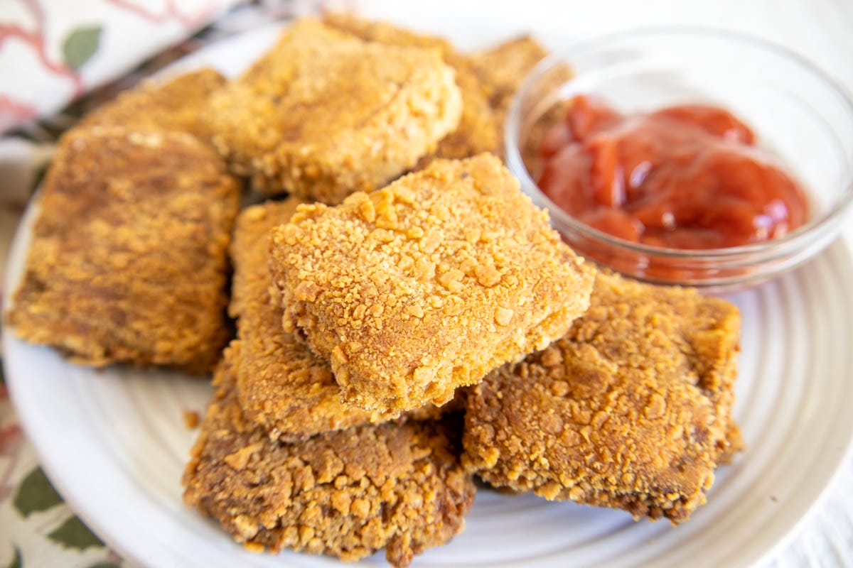 Panko Tofu on a plate with sauce.