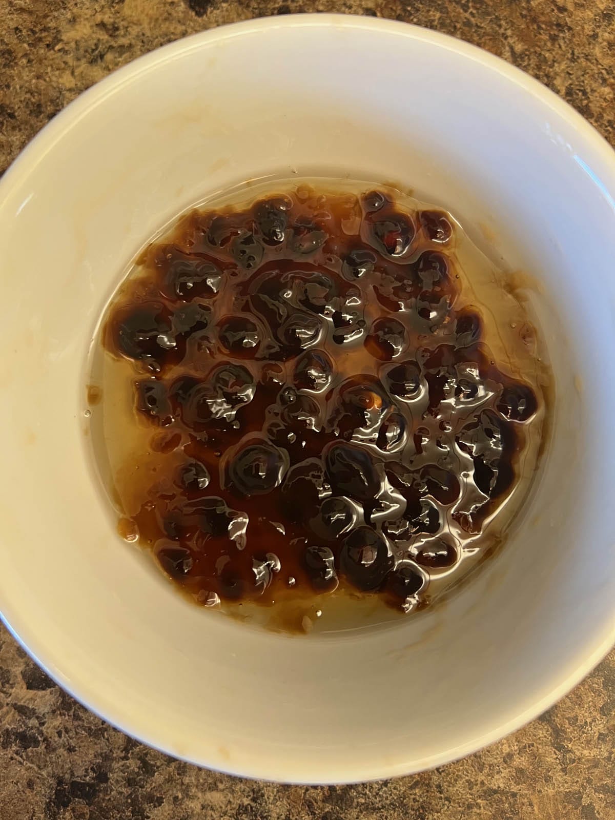 Tapioca boba in a bowl with lavender simple syrup.