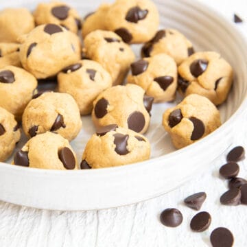 Cookie Dough Protein Bites with chocolate chips scattered about.