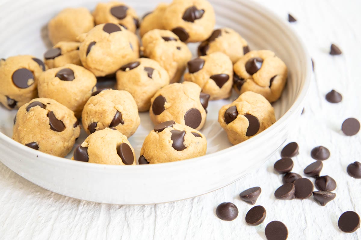 Cookie Dough Protein Bites with chocolate chips scattered about.